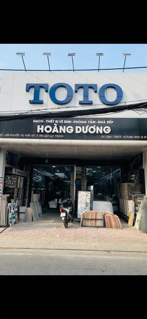 Cửa hàng TOTO với chữ màu xanh và văn bản 'HOANG DUONG' bên dưới.